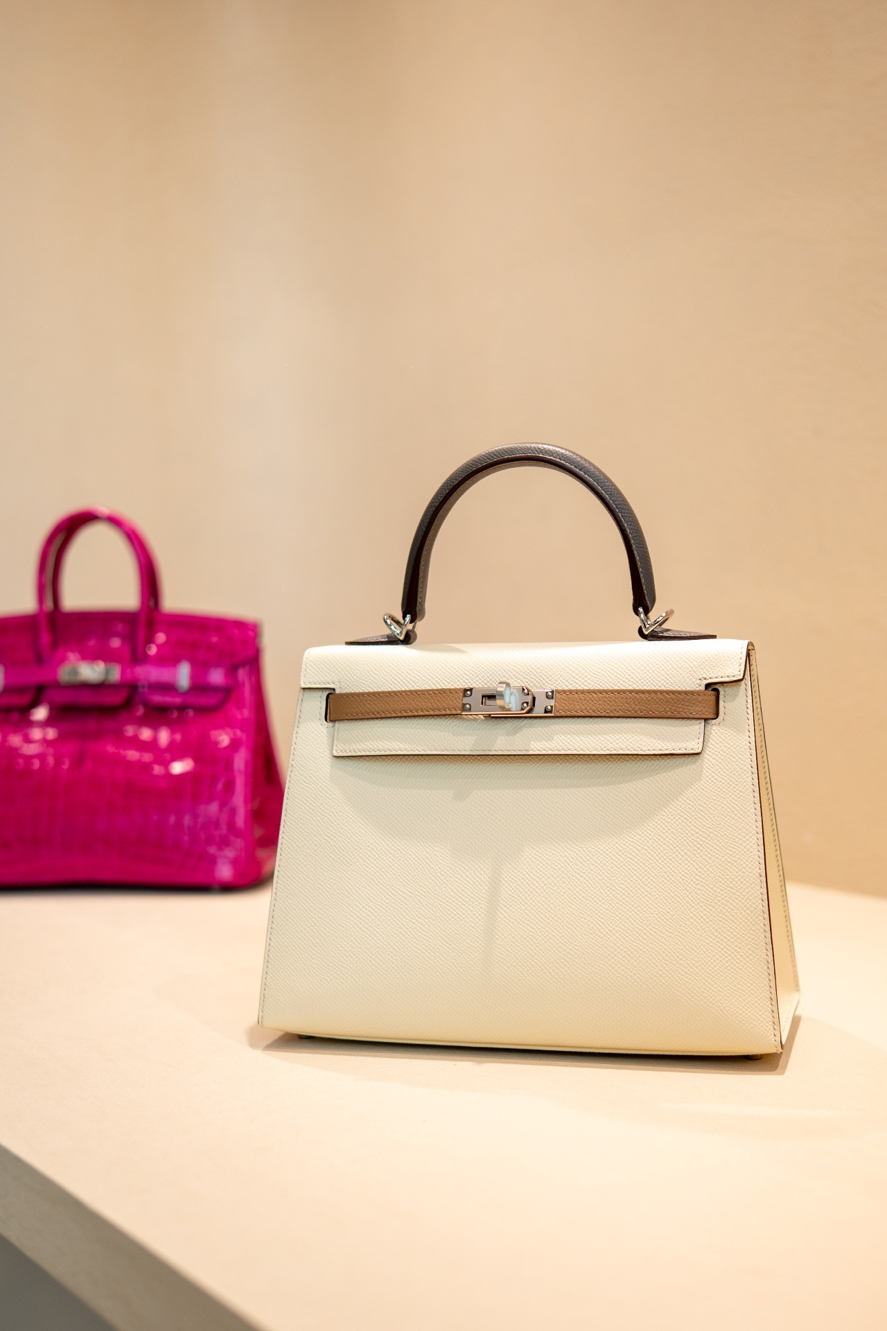 Hermès Kelly and Birkin displayed alongside the luxury watch retail offering.